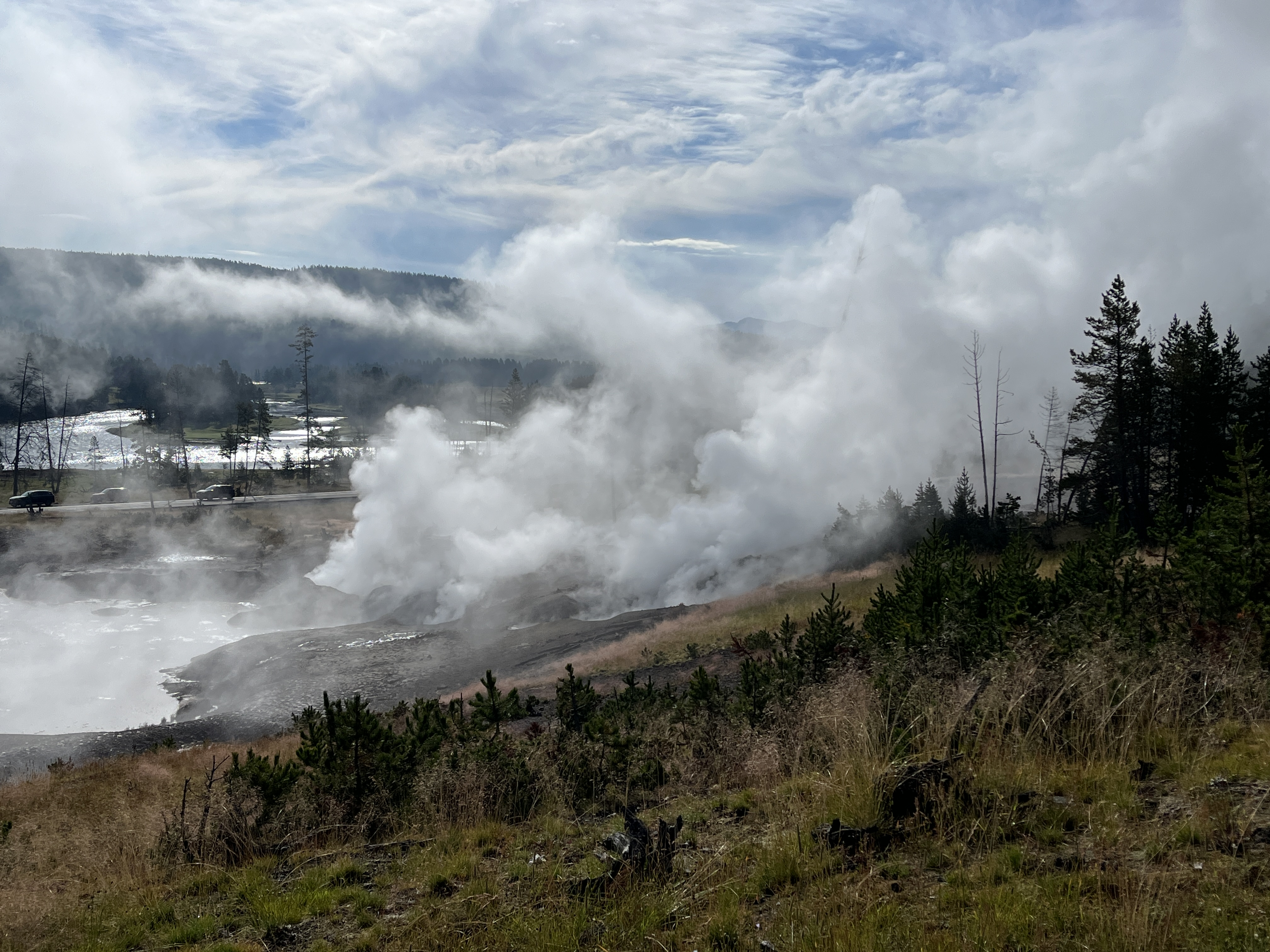 A large spring with cloud of sulfut smoke rising from it.